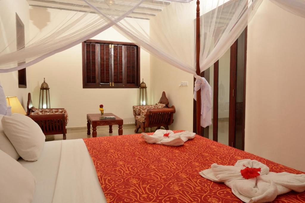 Four-poster canopy bed suite at JAZ Aurora, Zanzibar